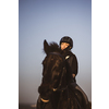 Female horse rider riding outdoors on her lovely horse