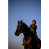 Female horse rider riding outdoors on her lovely horse