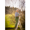 Senior gardener gardening in his permaculture garden - getting ready for the season, carrying out the necessary springtime tasks