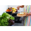 Young woman cooking in her modern kitchen (shallow DOF; color toned image)