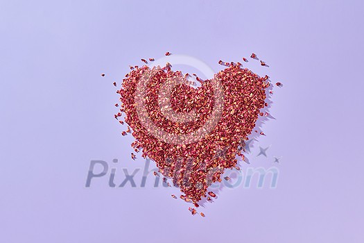 Dried red rose petals shaped as heart on toned background with copy space. Creative wedding invitation card design. Dried red rose petals shaped as heart on toned background with copy space. Creative wedding invitation card design.