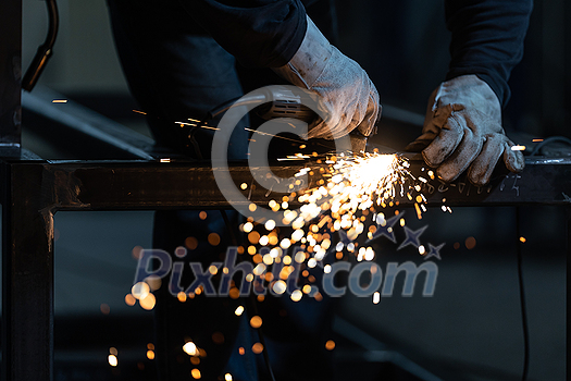 Man working on iron with grinder. Man at work. Sparkles and fire from grinder cutting. Grinder. Worker. Man working on iron with grinder. Man at work. Sparkles and fire from grinder cutting. Grinder. Worker.