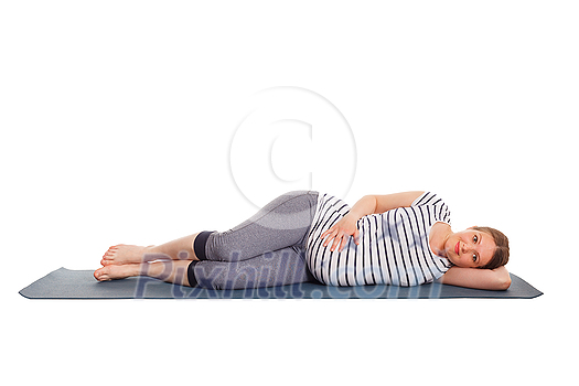 Pregnancy yoga exercise - pregnant woman doing yoga asana Parsva Savasana Side Fetal Pose or Side Lying Corpse Pose isolated on white background