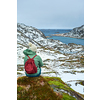 Woman tourist traveler enjoying a view of fjord in winter. Lofoten islands, Norway