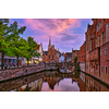 Evening dusk picturesque view of Bruges Brugge town canal with bridge and medieval houses, Belgium