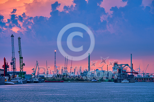 Port of Antwerp with harbor cranes in twilight and a ship passing under brigde Antwerp, Belgium Port of Antwerp with harbor cranes in twilight and a ship passing under brigde Antwerp, Belgium