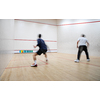 Squash players in action on a squash court (motion blurred image; color toned image)