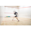 Squash player in action on a squash court (motion blurred image; color toned image)