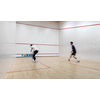 Squash players in action on a squash court (motion blurred image; color toned image)