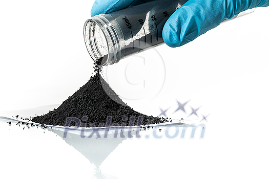 Iron nanoparticles in a lab, on a white glossy surface Iron nanoparticles in a lab, on a white glossy surface