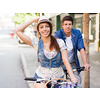 Happy young couple in city with bike