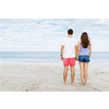 Young couple in love on the beach holding hands