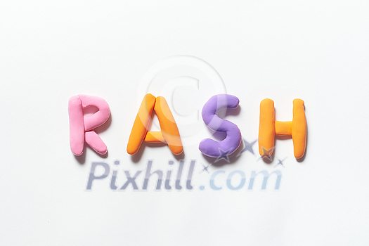 Rash word formed of colored plasticine on white background. Skin disease and medical treatment concept.
