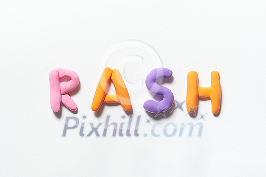 Rash word formed of colored plasticine on white background. Skin disease and medical treatment concept. Rash word formed of colored plasticine on white background. Skin disease and medical treatment concept.