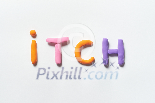 Itch word formed of colorful plasticine on white background. Skin disease and medical treatment concept.