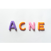 Acne word formed of vivid plasticine on white background. Skin disease and medical treatment concept.