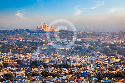 Aerial view of Jodhpur cityscape - the Blue city - with Umaid Bhawan Palace on horizon on sunset. View from Mehrangarh Fort. Jodphur, Rajasthan, India Aerial view of Jodhpur cityscape - the Blue city - with Umaid Bhawan Palace on horizon on sunset. View from Mehrangarh Fort. Jodphur, Rajasthan, India