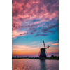 Netherlands rural landscape with windmills at famous tourist site Kinderdijk in Holland on sunset with dramatic sky