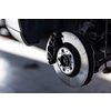 Car in a garage for maintenance, oil/tyre change (shallow DOF; color toned image)