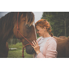 Pretty, young, redhead woman with her lovely horse, during her favorite leisure