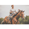 Pretty, young, redhead woman with her lovely horse, during her favorite leisure