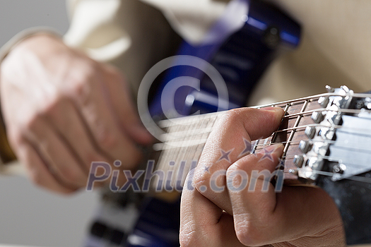 Close up of male hands playing electric guitar