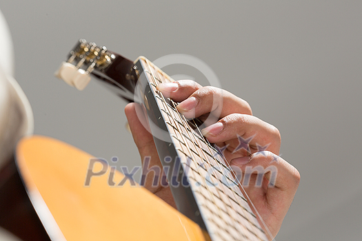 Close up of male hands playing acoustic guitar Close up of male hands playing acoustic guitar