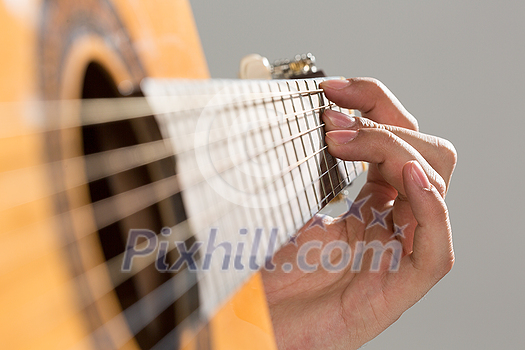 Close up of male hands playing acoustic guitar Close up of male hands playing acoustic guitar