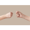 Two hands of man and woman in fist are about to bump symbol of friendship or aggression isolated on beige background. Brotherhood awesome fists bump as agreement.