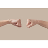 Two hands male and woman fist bumping symbol of friendship, good job, great work isolated on beige background. Brotherhood awesome fists bump as agreement.