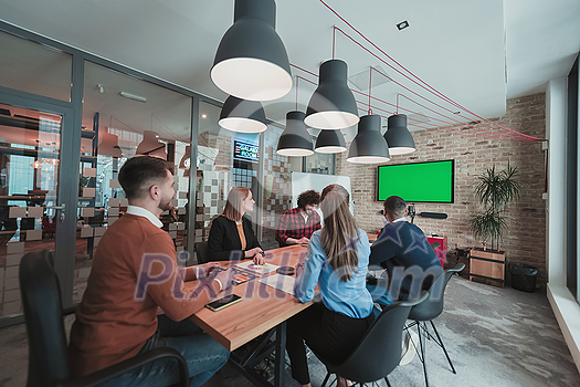 Successful team. Group of young multi-ethnic business people working and communicating together in creative office. Selective focus. High-quality photo