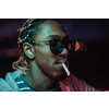 Afro Americans smoking a cigar, in the background city lights. High quality photo