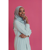 Portrait of young modern Muslim beauty wearing traditional Islamic clothes on plastic pink background. Selective focus. High-quality photo