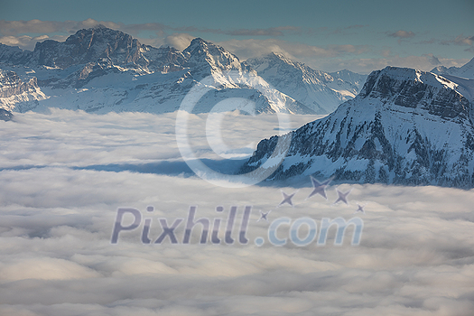 Splendid apline scenery. High mountains with fog and lovely evening light.