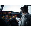 Pilot's hand accelerating on the throttle in  a commercial airliner airplane flight cockpit during takeoff