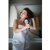 Woman taking a long hot shower washing her hair in a modern design bathroom