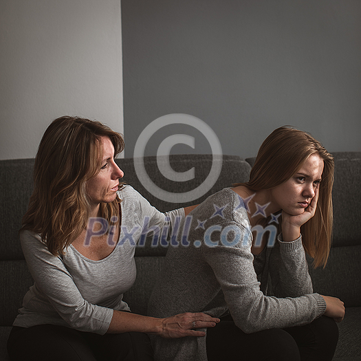 Depressed teen suffering from anxiety being taken care of by her caring mother Depressed teen suffering from anxiety being taken care of by her caring mother