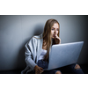 Pretty, young woman with her laptop studying for an exam/working