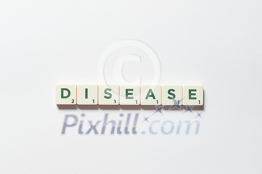 Disease word formed of scrabble blocks on white background. Disease prevention and physical health awareness.