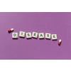 Disease word formed of scrabble blocks and pharmaceutical pills over purple background. Health and medical treatment concept.