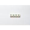 Care word formed of scrabble blocks over white background. Health insurance and protection concept.