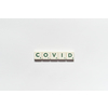 Covid word formed of scrabble blocks on white background. Coronavirus infection and medical treatment concept.