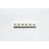 Corona word formed of scrabble blocks on white backdrop. Coronavirus infection and medical treatment concept.