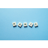 Panic word formed of messy scrabble tiles on blue backdrop. Anxiety and mental health awareness.