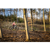 Pretty, young woman with her mountain bike going for a ride past the city limits, getting the daily cardio dose - close-up portrait (motion blurred image)