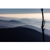 Mountain atmospheric landscape of high mountains in thick fog in rainy weather, panorama of mountain tops in thick clouds, dawn in the mountains in early spring.