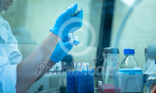 Female researcher carrying out research experiment in a chemistry lab Female researcher carrying out research experiment in a chemistry lab