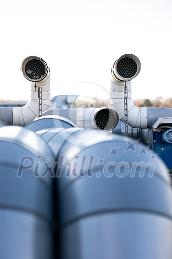 External unit of commercial air conditioning and ventilation system installed on industrial building roof. Exhaust vent on flat factory rooftop External unit of commercial air conditioning and ventilation system installed on industrial building roof. Exhaust vent on flat factory rooftop