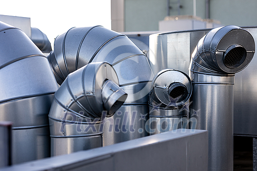 External unit of commercial air conditioning and ventilation system installed on industrial building roof. Exhaust vent on flat factory rooftop External unit of commercial air conditioning and ventilation system installed on industrial building roof. Exhaust vent on flat factory rooftop