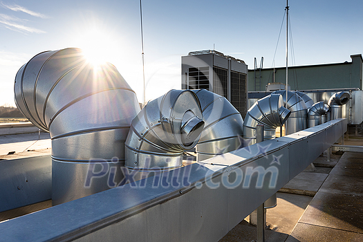 External unit of commercial air conditioning and ventilation system installed on industrial building roof. Exhaust vent on flat factory rooftop External unit of commercial air conditioning and ventilation system installed on industrial building roof. Exhaust vent on flat factory rooftop